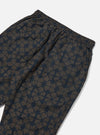 Close-up of the back of the Navy Mitla Print Cotton Hi Water Trouser on a white background. The cotton trousers have a navy and brown geometric print and an elasticated waist.