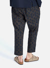 A person wears the Navy Mitla Print Cotton Hi Water Trouser, a cropped style with a geometric print, on a white background. The fit is relaxed and casual.