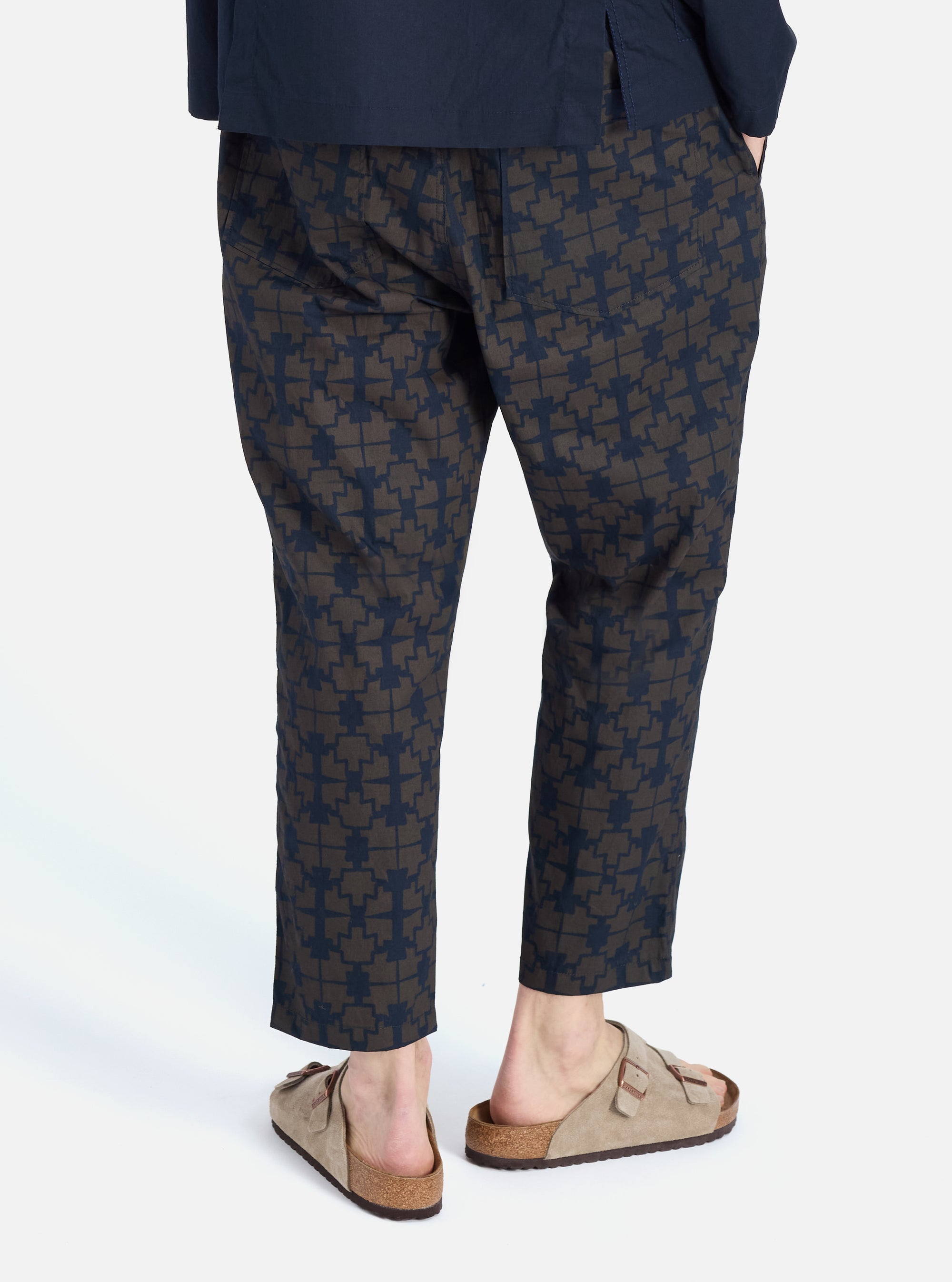 A person wears the Navy Mitla Print Cotton Hi Water Trouser, a cropped style with a geometric print, on a white background. The fit is relaxed and casual.