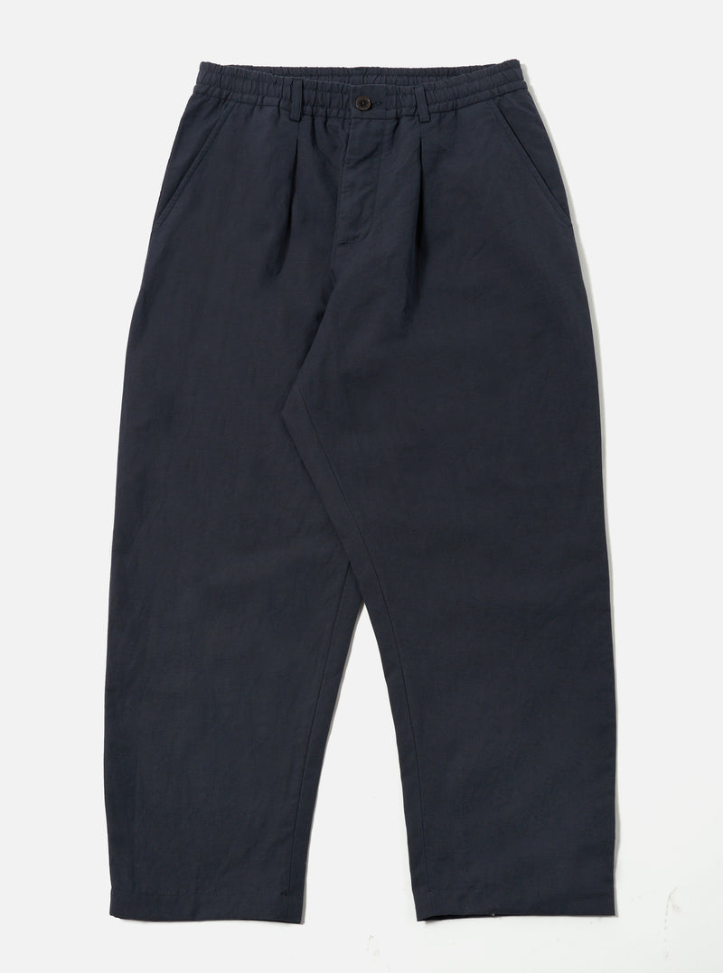 The Navy Linen Slub Weave Oxford Pant, in navy linen, is laid flat on a white background. The pants have a relaxed fit and an elastic waistband.