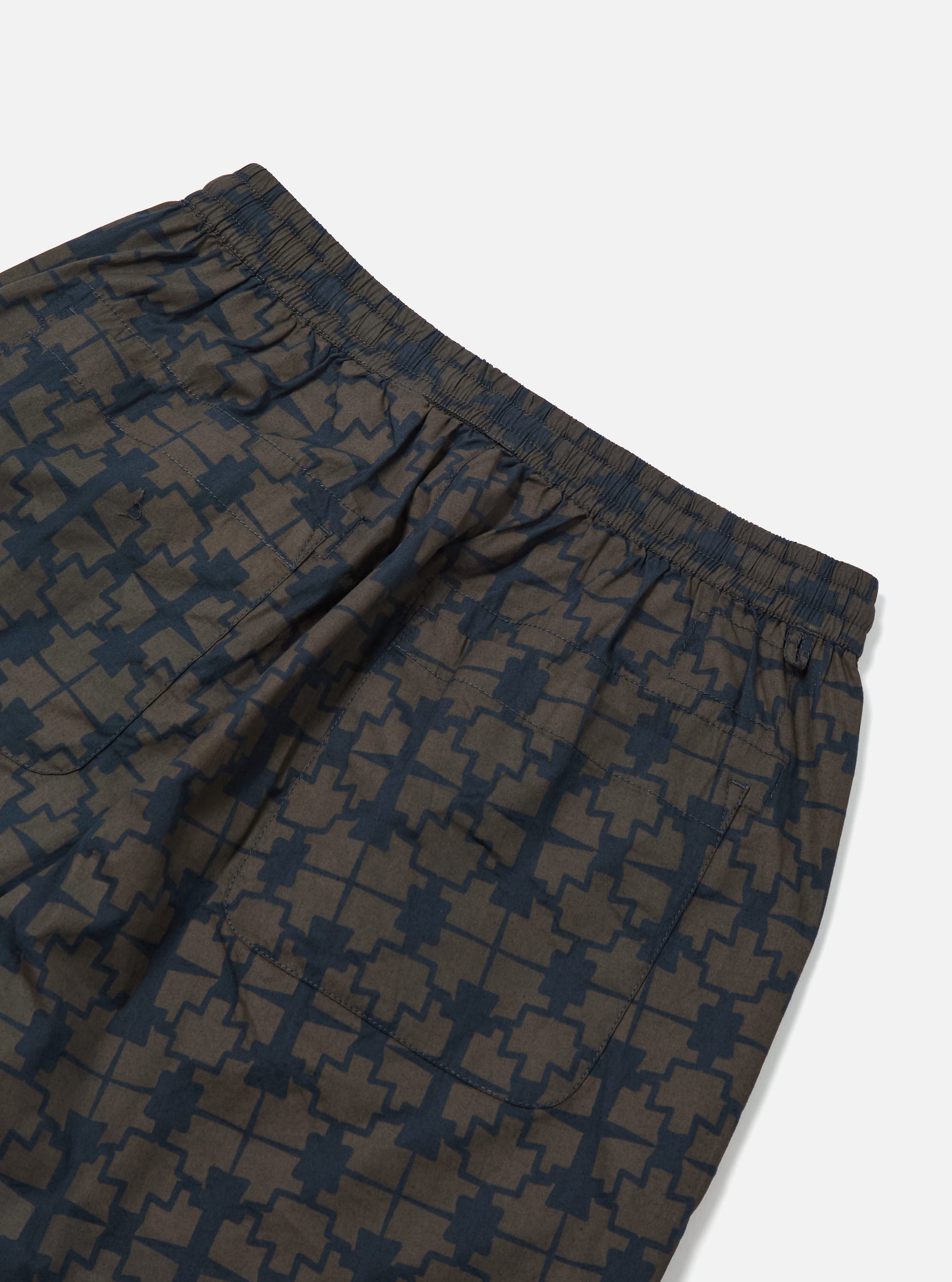 Close-up of the Navy Mitla Print Cotton Simple Short, showcasing the navy pattern on cotton. Elastic waist and back pocket visible. Shot on a white background.