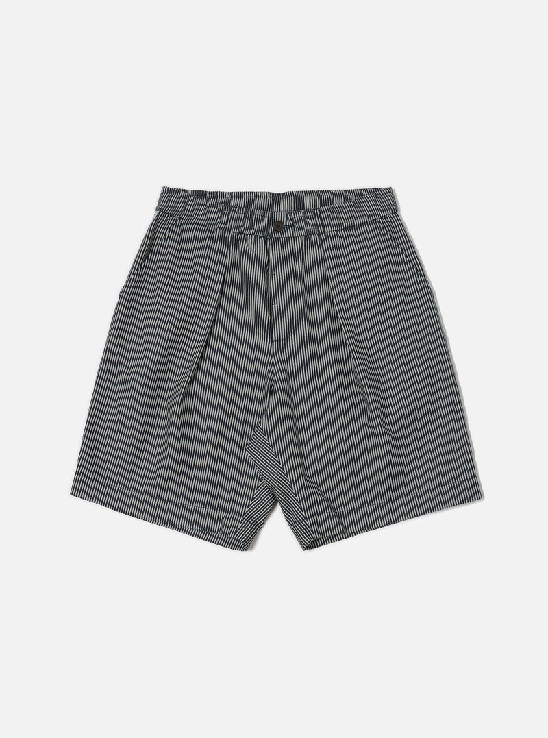 The Indigo Hickory Stripe Denim Pleated Track Short is displayed on a white background. The shorts are pleated and made of denim with indigo and white stripes.