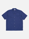The Blue Linen Cotton Shirting Camp Shirt is laid flat on a white background. The shirt is a solid blue, short sleeved, and has a pocket on the right breast.
