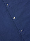 Close-up of the Blue Linen Cotton Shirting Camp Shirt showing the fabric texture and button details. The shirt is laid flat on a neutral surface.