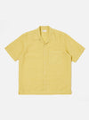 Studio shot of the Lemon Linen Cotton Shirting Camp Shirt. The lemon-colored shirt is laid flat on a white background. The shirt has short sleeves, a camp collar, and a chest pocket.