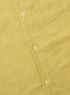 Close-up of the lemon-colored Lemon Linen Cotton Shirting Camp Shirt, showcasing the fabric texture, buttons, and pocket detail on a flat surface.