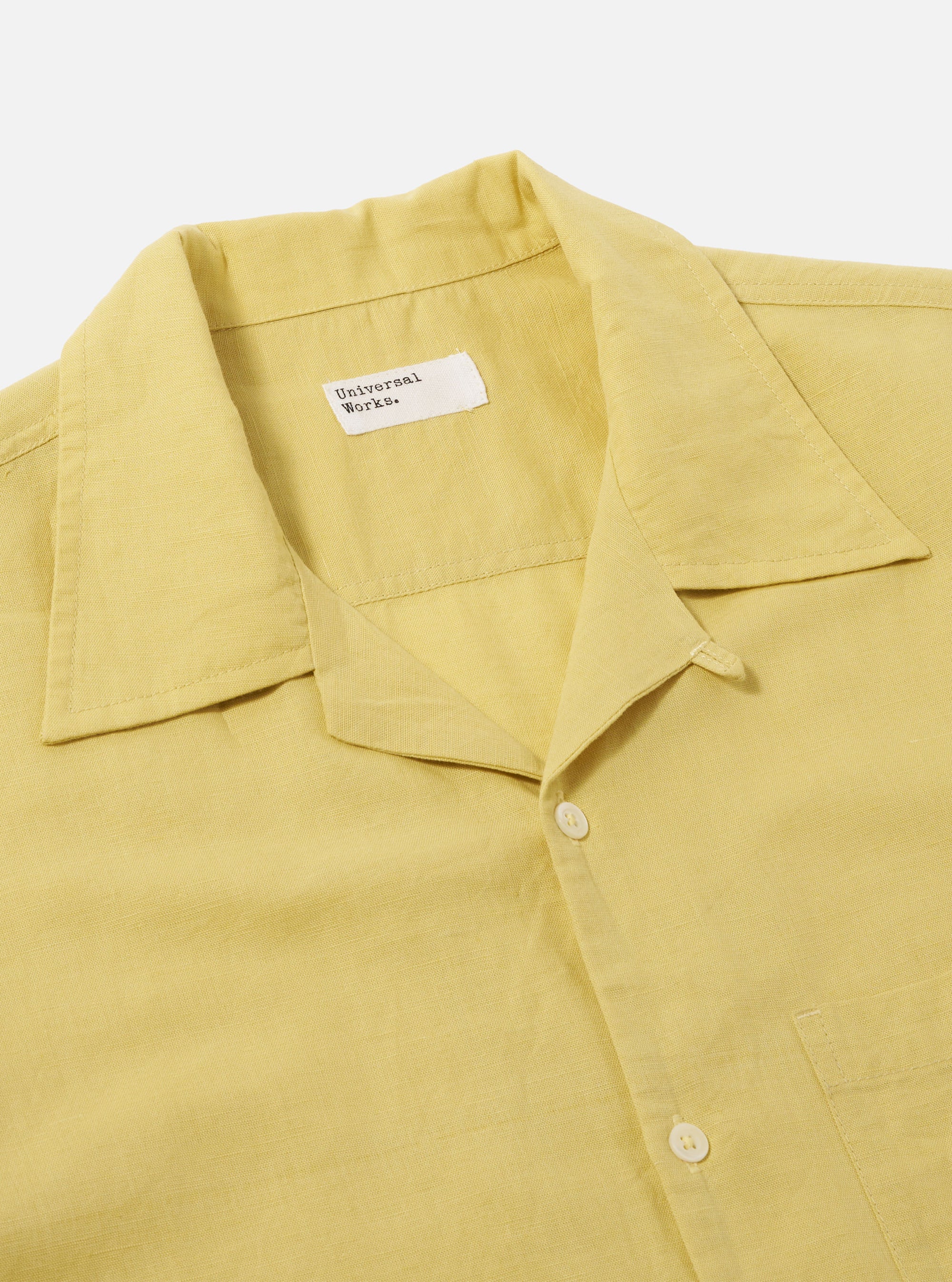Close-up of the Lemon Linen Cotton Shirting Camp Shirt on a white background. The shirt is a light yellow color and has a camp collar.