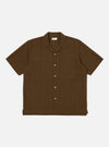 The Brown Dobby Self Stripe Camper Shirt is laid flat on a white background. The shirt is brown with a subtle stripe pattern and has short sleeves and a camp collar.