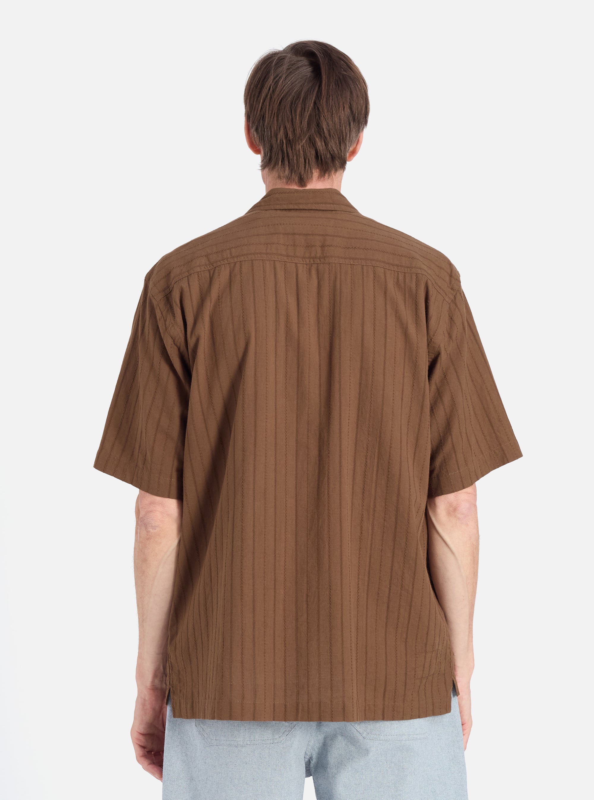 Back view of a model wearing a Brown Dobby Self Stripe Camper Shirt. The shirt has a subtle vertical stripe pattern. Shot against a white backdrop.