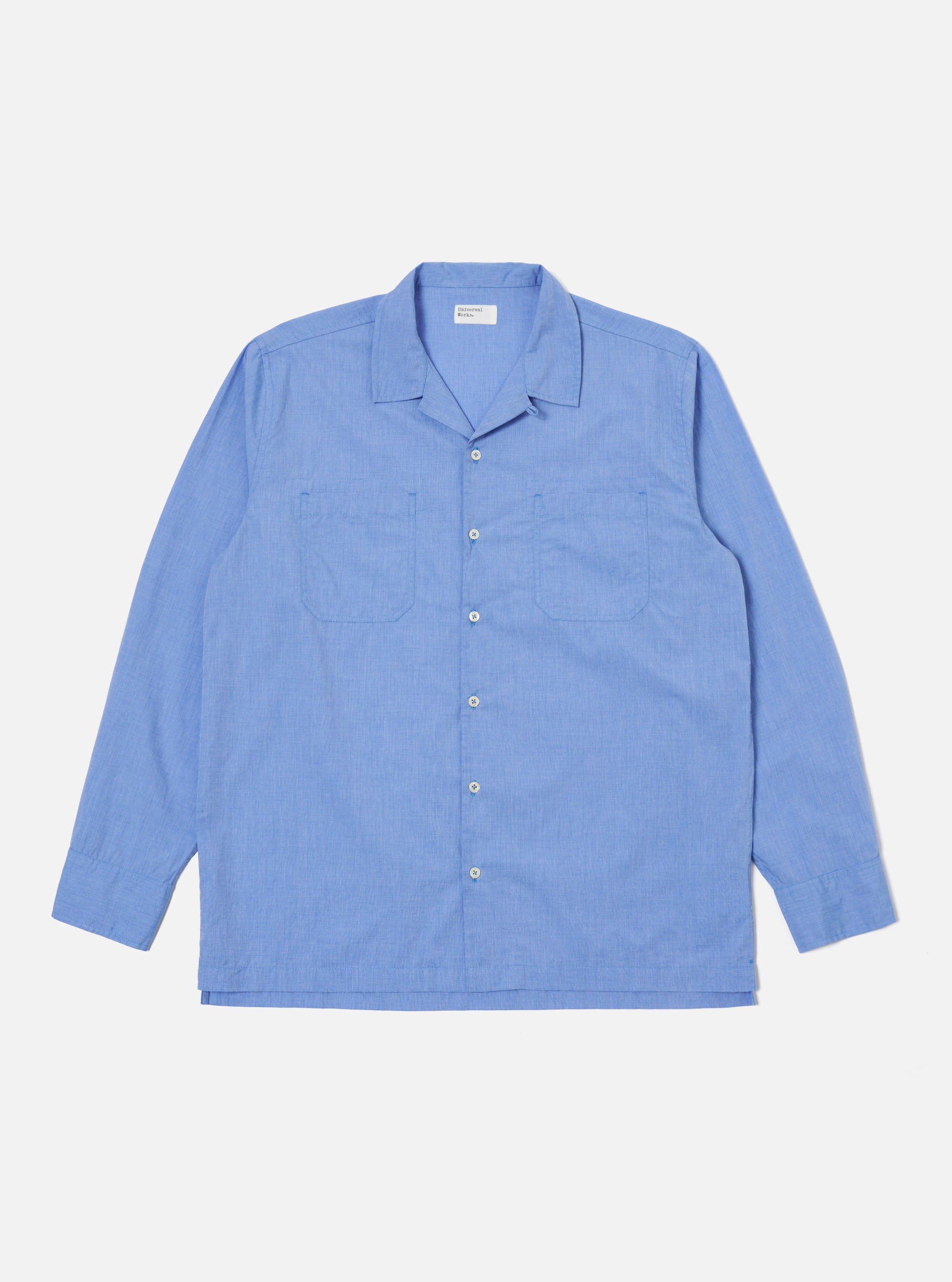 Flat lay of a Blue End On End Cotton Garage Shirt on a white background. The shirt is long-sleeved with two chest pockets.