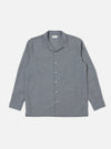 The Grey End On End Cotton Garage Shirt is laid flat on a white background. This long-sleeved shirt has a camp collar, two chest pockets, and a button-up front.
