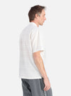 A man models the Ecru Deffe Self Stripe Minari Shirt in a studio shot against a white background. The shirt is a light color with subtle stripes.