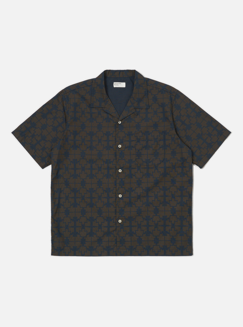 The Navy Mitla Print Cotton Road Shirt, featuring a navy and brown geometric pattern, is laid flat on a white background. The short-sleeved shirt has a camp collar and button-up design.