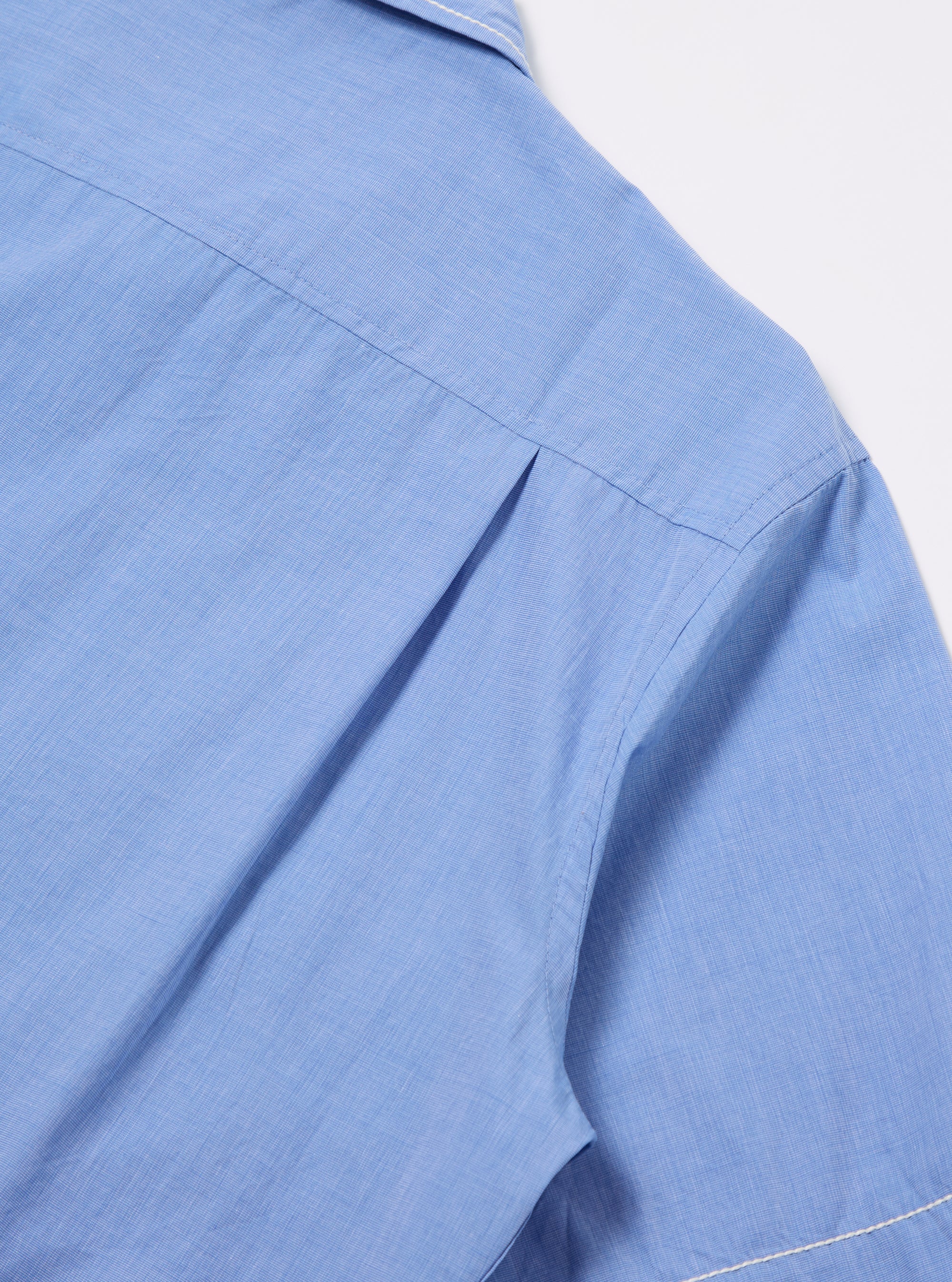 Close-up of the Blue End On End Cotton Utility SS Shirt on a white background. Shows the light blue cotton fabric and sleeve detail.
