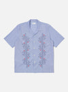 The Blue Classic Stripes Road Trip Shirt, light blue with red and navy embroidery, short sleeves, on a white background.