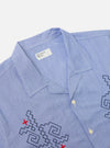 Close-up of the Blue Classic Stripes Road Trip Shirt on a white background. The shirt is light blue with black and red embroidery.