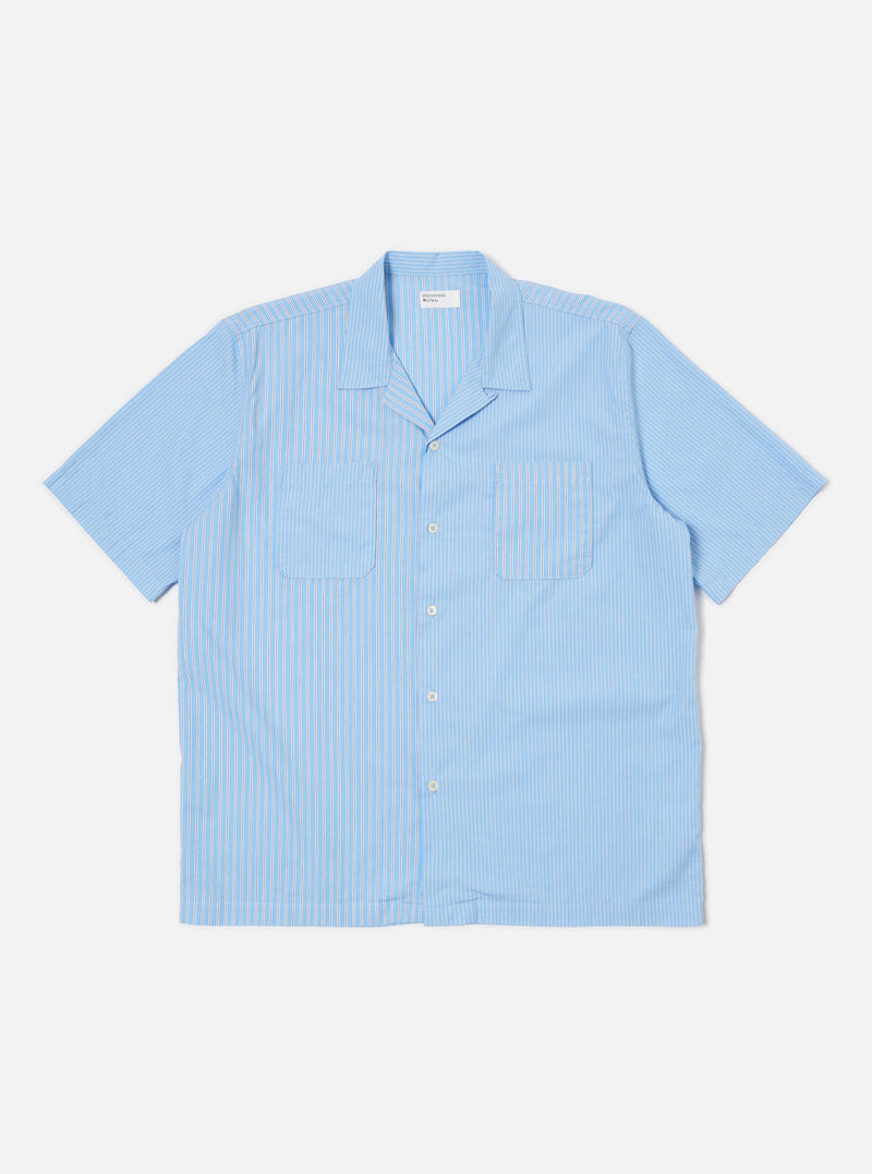 The Blue Vila Stripes Sal Road Shirt, a light blue and white striped short-sleeve shirt with two chest pockets, is laid flat on a white background.