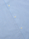 Close-up of the Blue Vila Stripes Sal Road Shirt, showcasing its light blue fabric with white and navy stripes and button details. The shirt is laid flat on a neutral surface.