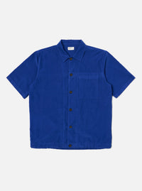 The Work Blue Summer Cord Tech Overshirt in vibrant blue corduroy. Short-sleeved, button-down on a clean white background. A stylish, lightweight overshirt.
