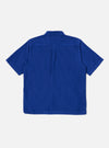 Back view of the Work Blue Summer Cord Tech Overshirt, a short-sleeved, blue corduroy shirt on a white background. The overshirt has a classic collar and a straight hem.