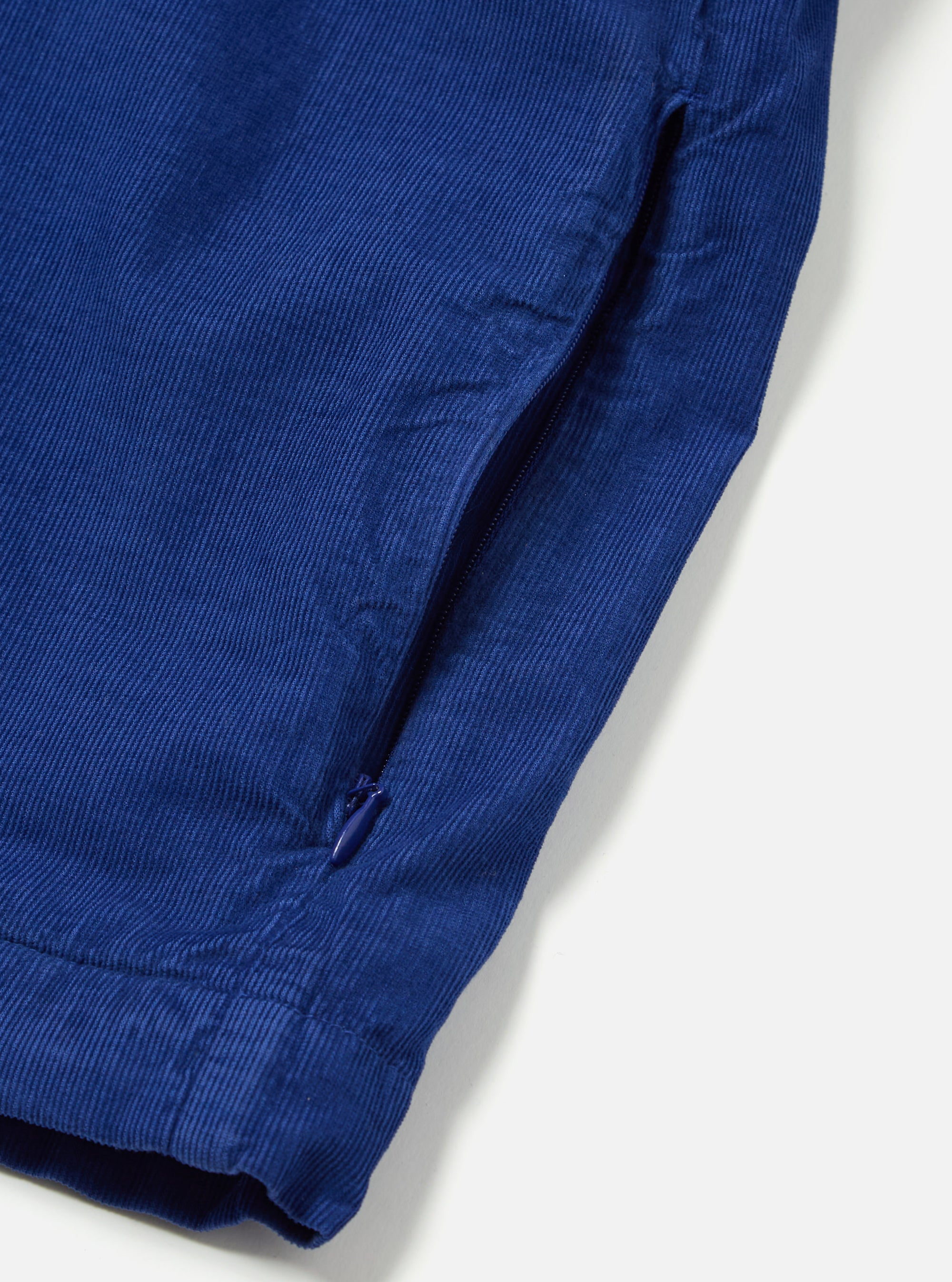 Close-up of the Work Blue Summer Cord Tech Overshirt showing the corduroy texture and a zippered pocket on a white background.