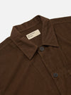 Close-up of the Khaki Summer Cord Tech Overshirt on a white background. The brown corduroy texture is visible, along with the collar, buttons, and Universal Works label.