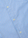 Close-up of the Blue Vila Stripes Patched Shirt. Features light blue and white stripes with navy accents, button-down style. Shot on a flat surface.