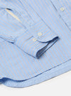 Close-up of the Blue Vila Stripes Patched Shirt on a white surface. Features blue and white stripes, buttoned cuffs, and a crisp, tailored fit.