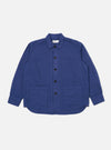 The Blue Linen Cotton Shirting Travail Overshirt is displayed on a white background. The blue overshirt features a button-down front and two front pockets.