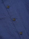 Close-up of the Blue Linen Cotton Shirting Travail Overshirt, showing the blue linen-cotton blend fabric and button details. The overshirt is neatly laid out on a flat surface.