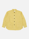 Studio shot of the Lemon Linen Cotton Shirting Travail Overshirt. The yellow overshirt is laid flat on a white background, showing the full button closure and two front pockets.
