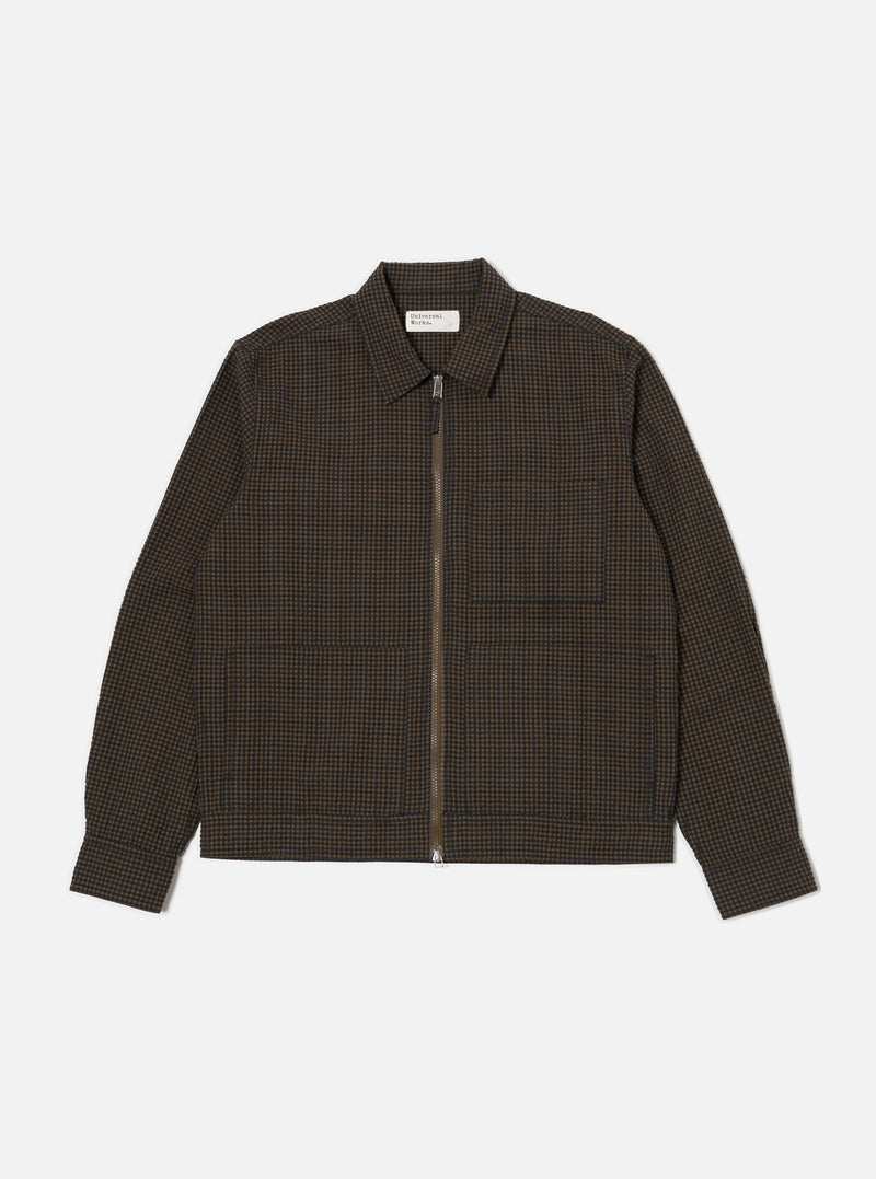 Close-up of the Navy Japanese Seersucker Zip Uniform Jacket on a white background. The jacket is a brown and black checkered pattern with a zip-up front and two pockets.