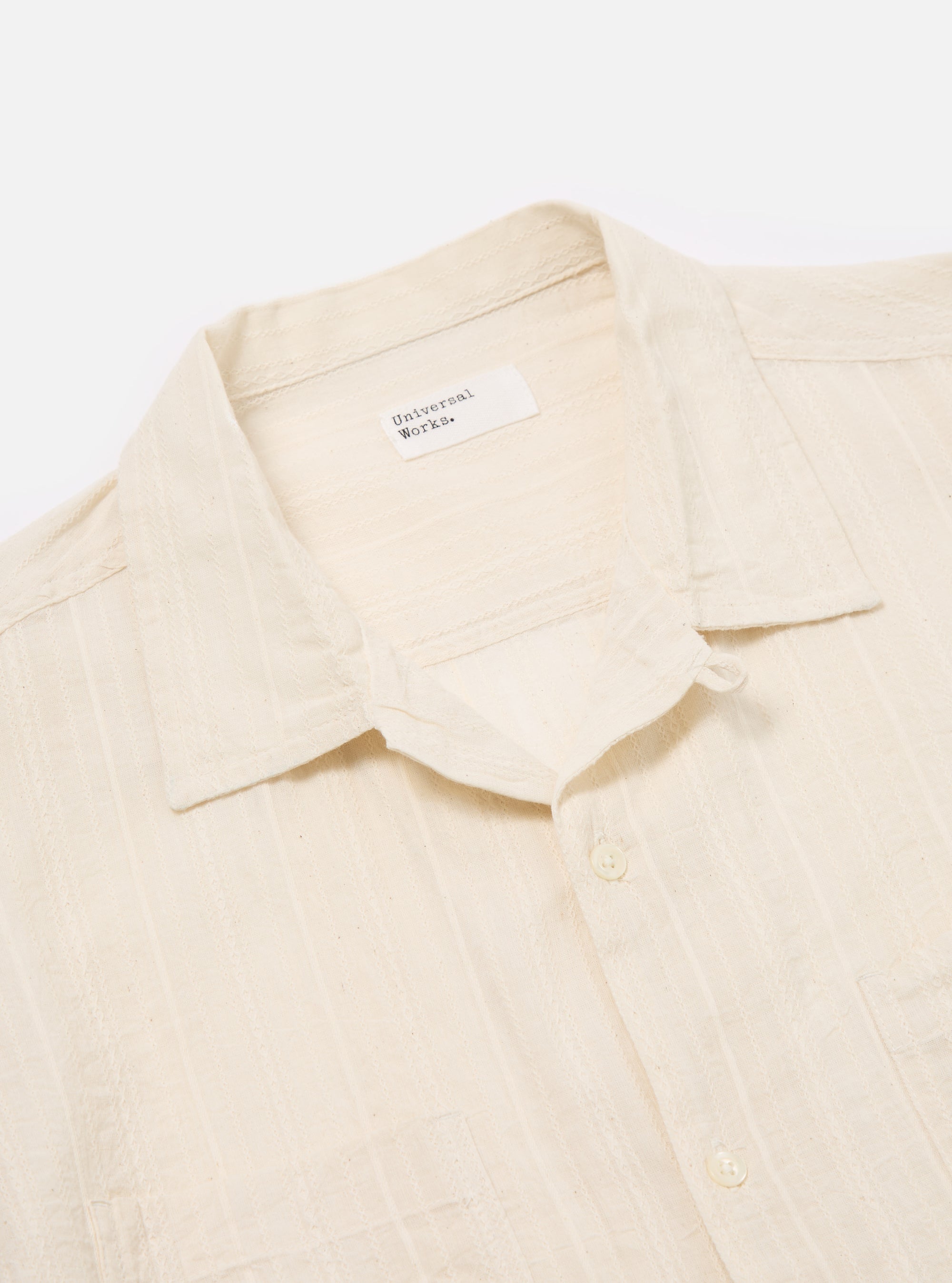 Close-up of the Ecru Acapulco Weave Work Shirt on a white background. The shirt is ecru-colored with a subtle woven texture. Features a camp collar and chest pockets.