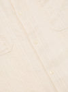 Close-up of the Ecru Acapulco Weave Work Shirt, showing the textured fabric, button closures, and chest pockets. The shirt is laid flat on a neutral surface.
