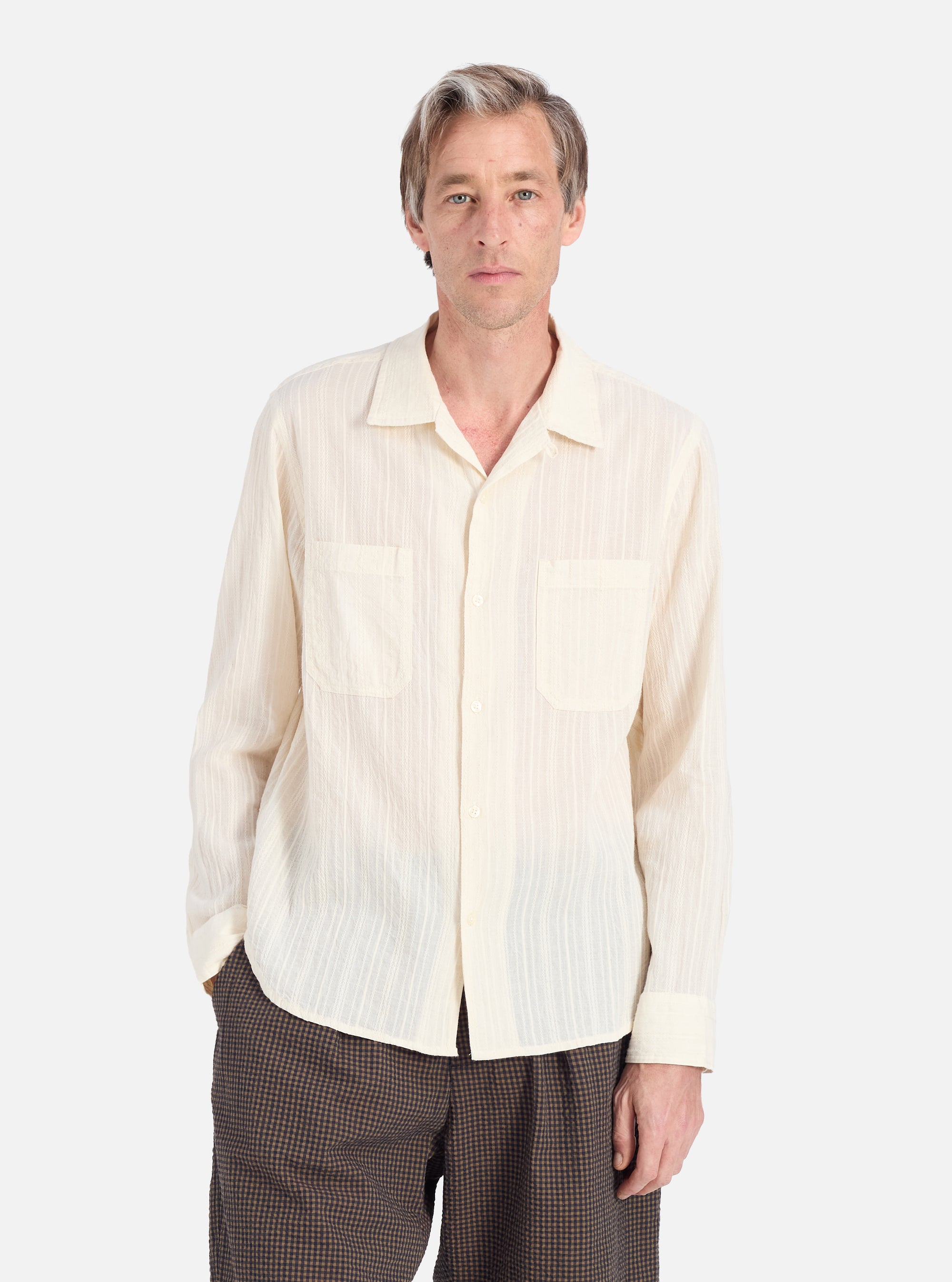 A man models the Ecru Acapulco Weave Work Shirt. The shirt is a light ecru color with a subtle weave pattern. He is standing against a plain white background.