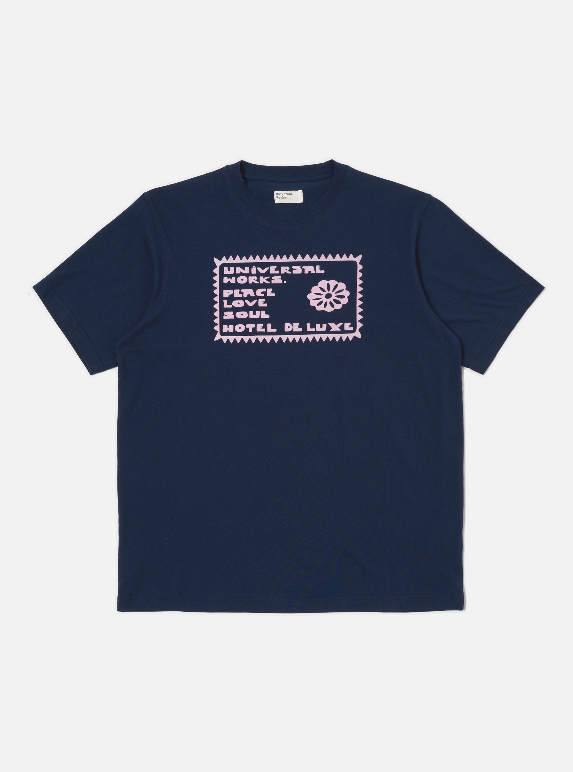 Close up of the Navy/Pink Single Jersey Pickup Print Tee on a white background. The tee is navy with a pink graphic print in the center.