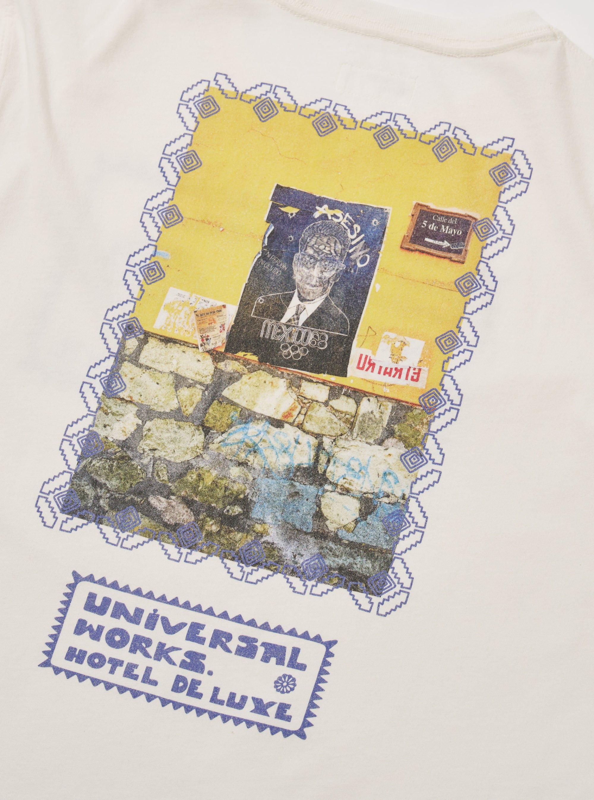 Close-up of the Ecru/Yellow Single Jersey Pickup Print Tee. Features a graphic print with blue details. The tee is laid flat on a neutral surface.