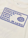 Close-up of the Ecru/Yellow Single Jersey Pickup Print Tee. The tee is ecru with a blue graphic print. The background is a plain white surface.