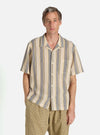 A model wears a Grey/Yellow Cotton Lattice Road Shirt. The shirt has vertical stripes. The background is a clean white.