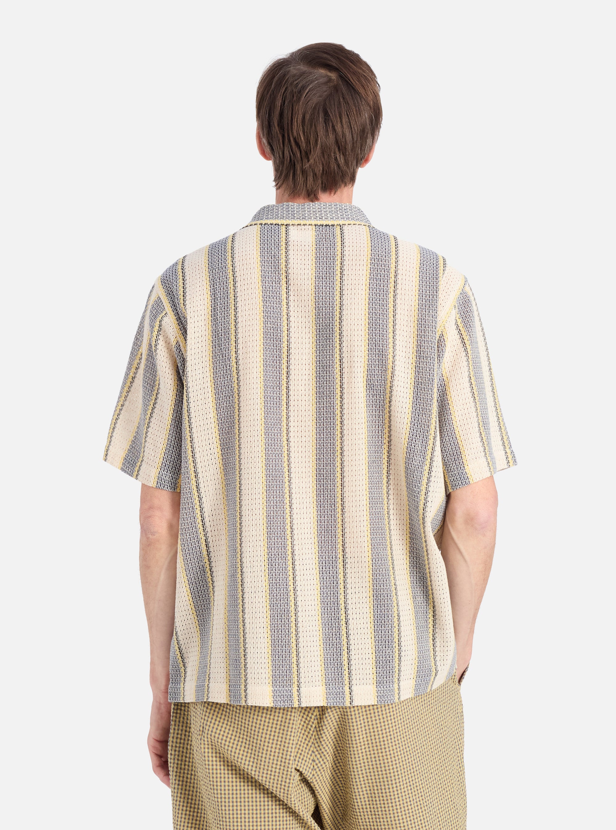 Back view of a model wearing the Grey/Yellow Cotton Lattice Road Shirt. The shirt features vertical stripes. The background is a clean, bright white.