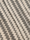 Close-up of the Charcoal Cotton Lattice Road Shirt. The shirt has a charcoal lattice pattern on a cream cotton fabric. White buttons are visible.