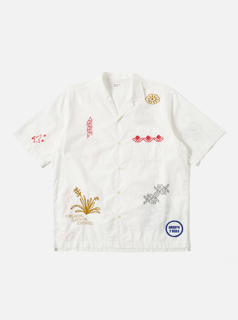 The Ecru Embroidered Poplin Minari Shirt on a white background. The short sleeve shirt has red, gold, and black embroidery. The shirt is made of poplin.