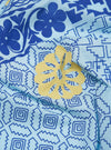 Close-up of the Blue Cambric Kingsman Neckerchief. The light blue fabric features a dark blue floral and geometric pattern, with a yellow floral accent.