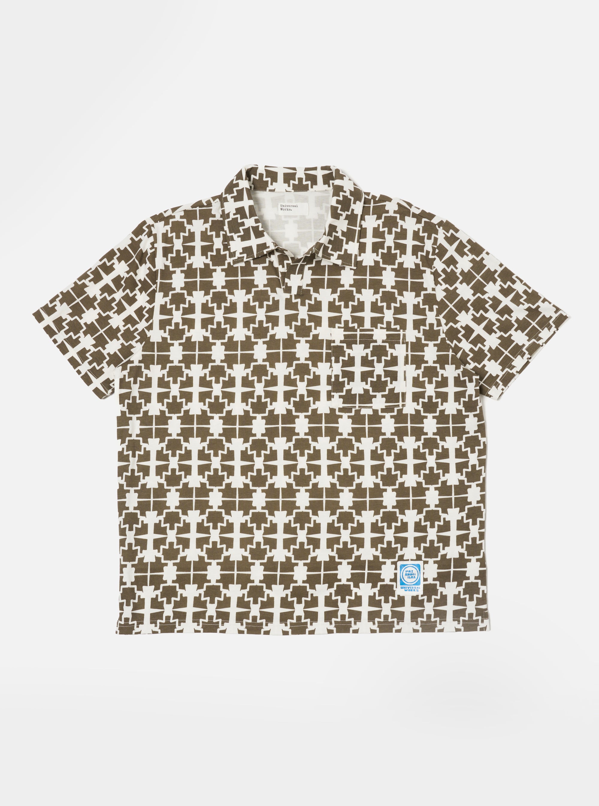 The Ecru/Mud Mitla Print Jersey Newlyn Polo shirt, featuring a geometric pattern, is laid flat on a white background. The polo is ecru with a mud-colored print.