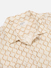 Close-up of the Camel Mitla Weave Work Shirt on a white background. The shirt is off-white with a brown woven pattern. The collar is visible.