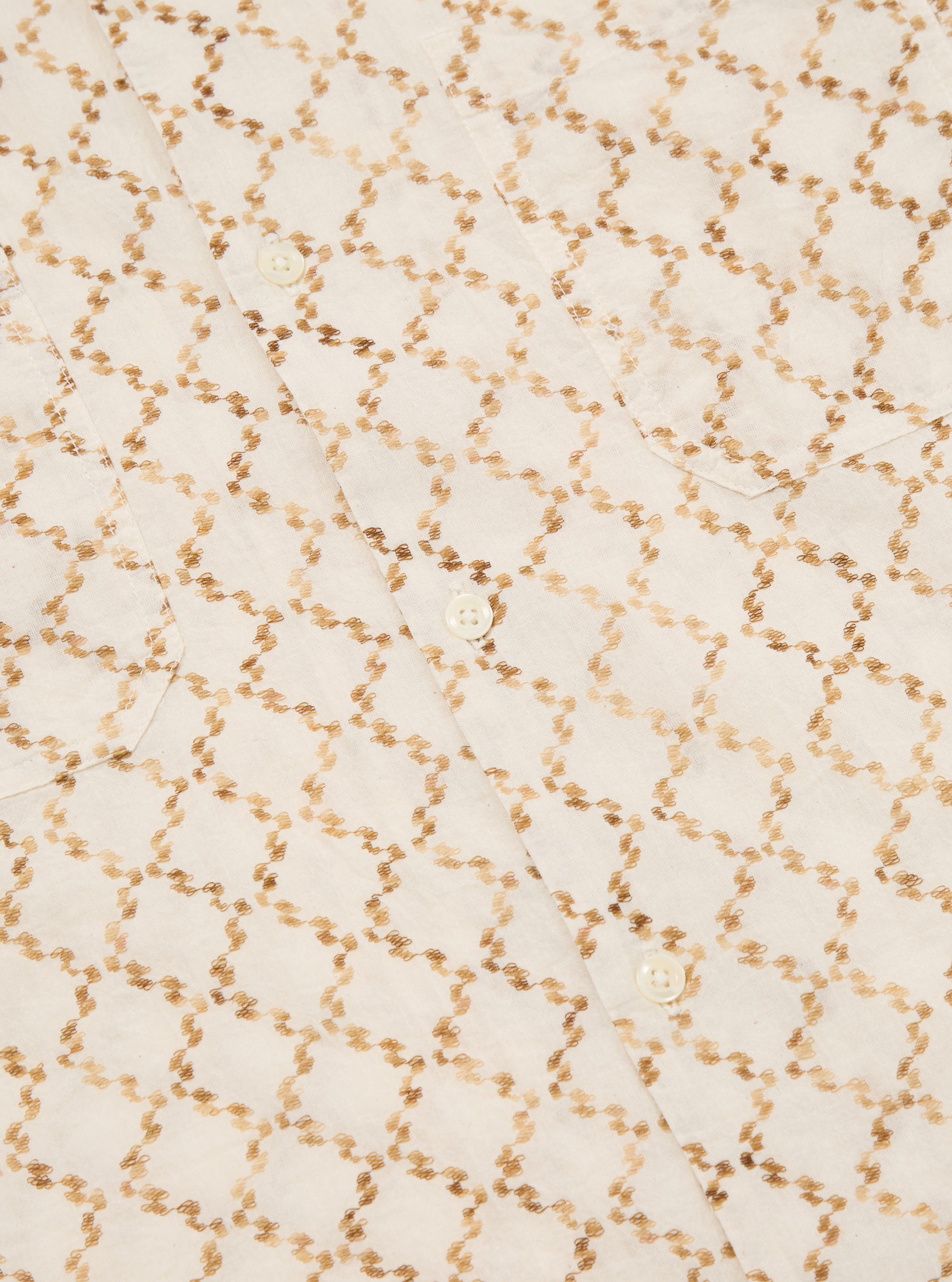 Close-up of the Camel Mitla Weave Work Shirt.  The shirt is white with a brown woven pattern.  It has a button-down front and a chest pocket.