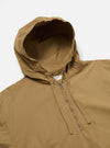 Close-up of the Dark Sand Peach Recycled Nylon Liam Jacket, featuring a hood, half-zip, and drawstring. The jacket is laid flat on a white surface.