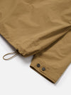 Close-up of the Dark Sand Peach Recycled Nylon Liam Jacket showing the sleeve with button details and drawstring on a white background.