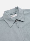 Close-up of the Indigo Reworked Jean Cloth Rose Bowl Jacket in light blue denim. Features a collared neck, front zipper, and chest pocket. Shot on a white background.
