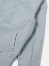Close-up of the Indigo Reworked Jean Cloth Rose Bowl Jacket, showing the light blue denim material and pocket details. Shot on a white background.